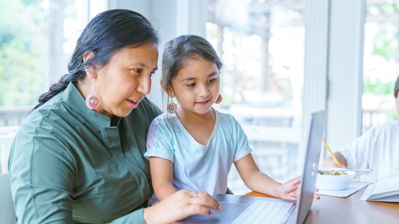 mother and daughter looking at laptop