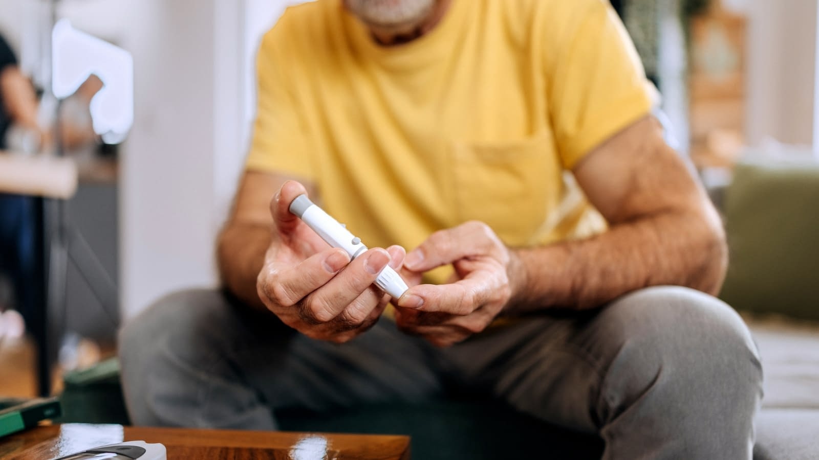 Nov 21 blog older man taking his blood sugar with test