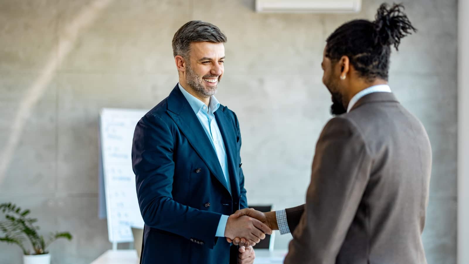 African-American man shaking hands with Caucasian male business partner