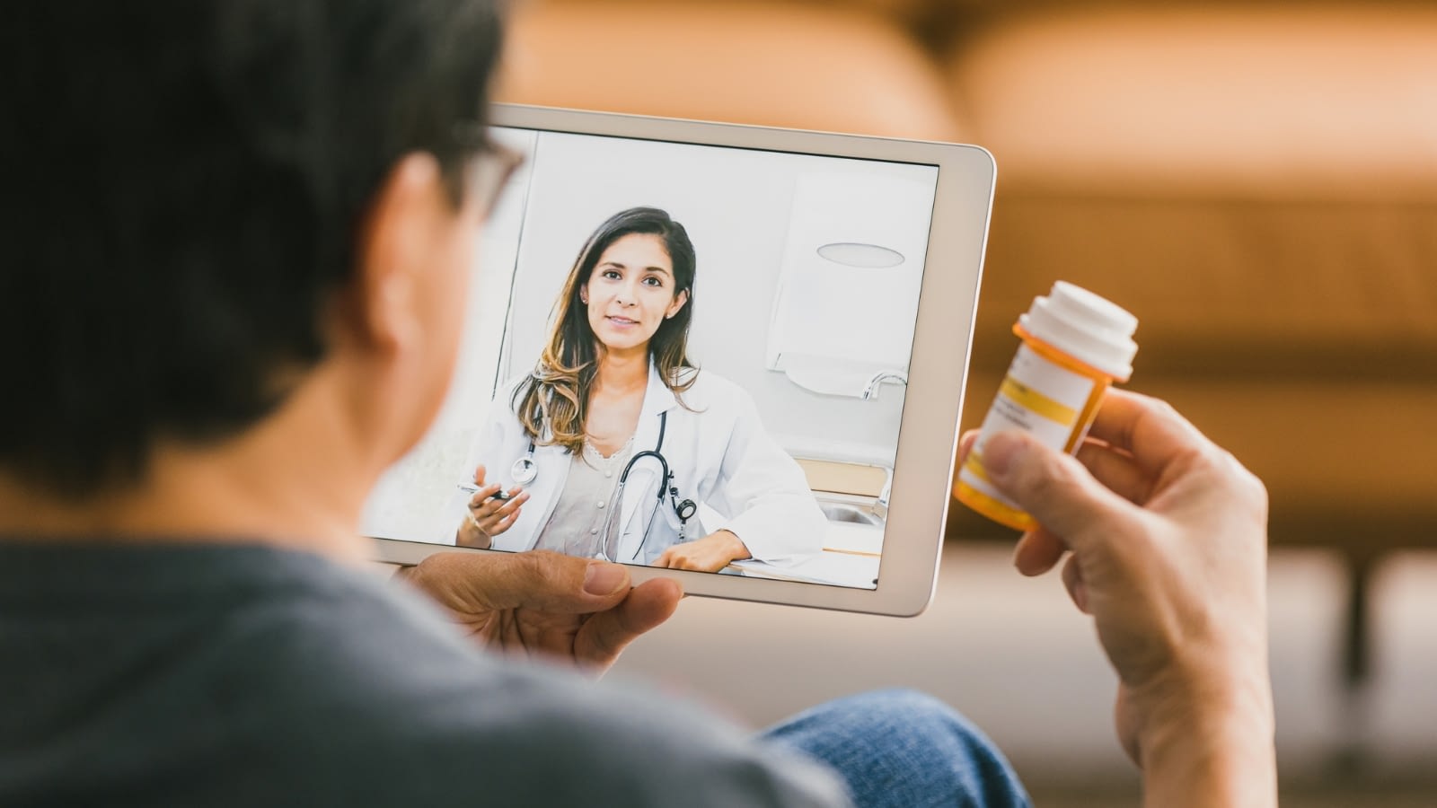 senior showing telehealth doctor his medicine