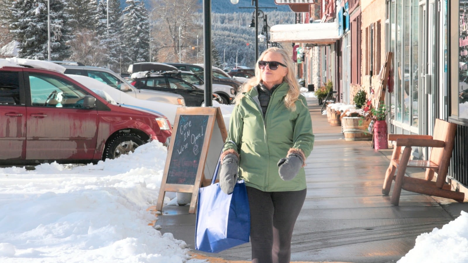 woman strolling on icy downtown sidewalk shopping