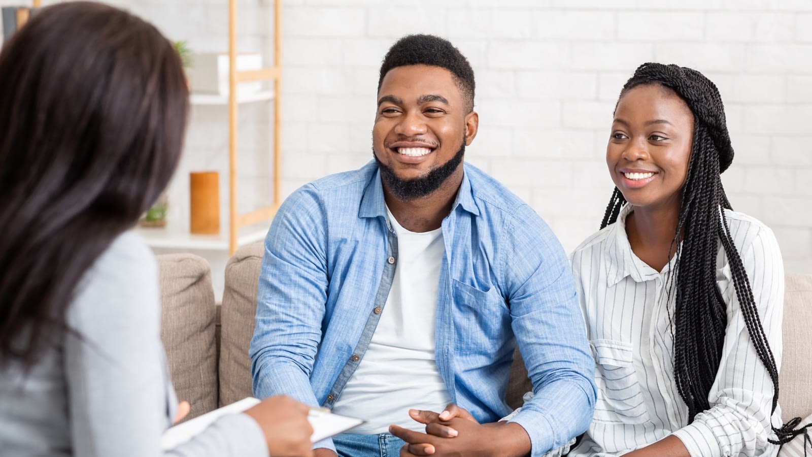 young African American couple discussing life insurance with agent