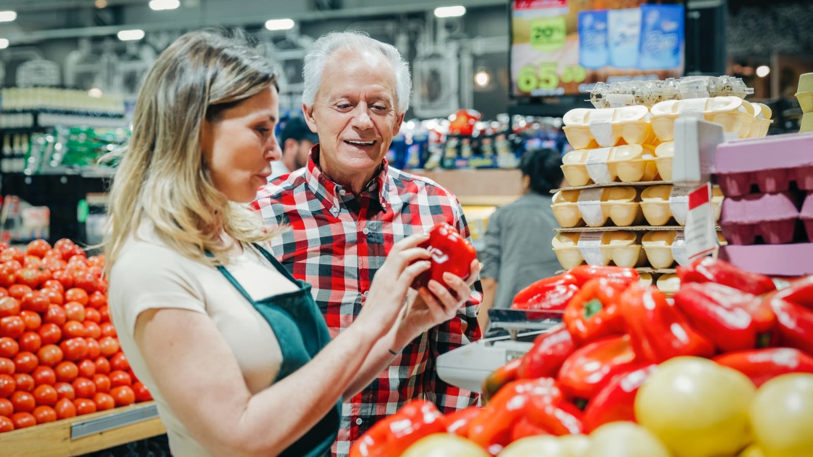 elderly man picking out produce.