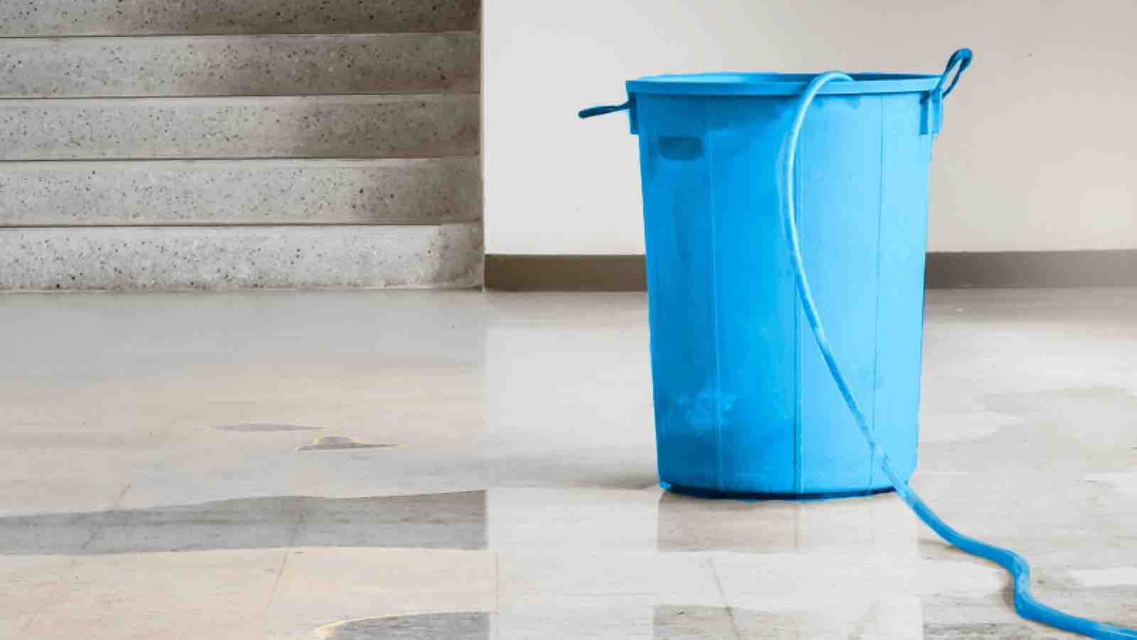 water-damage-large Bucket catching dripping ceiling water