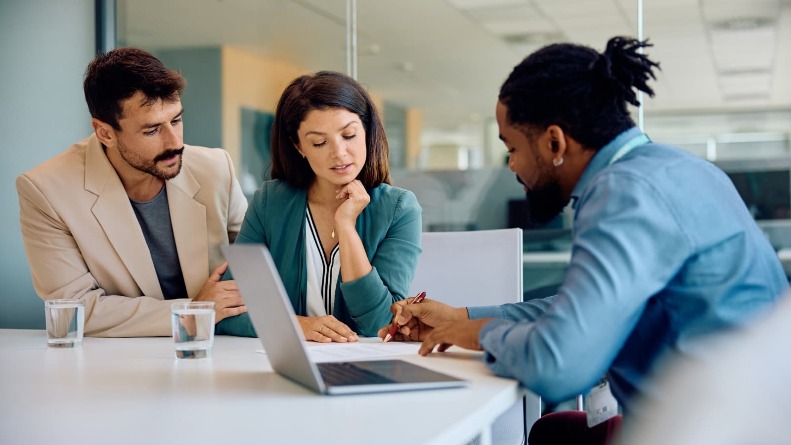 Feb 7 Young couple speaking with their insurance agent about life insurance