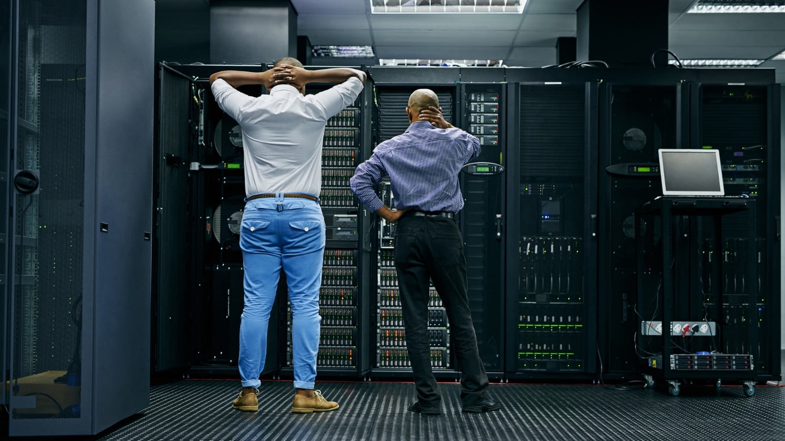 two men standing in front of malfunctioning equipment