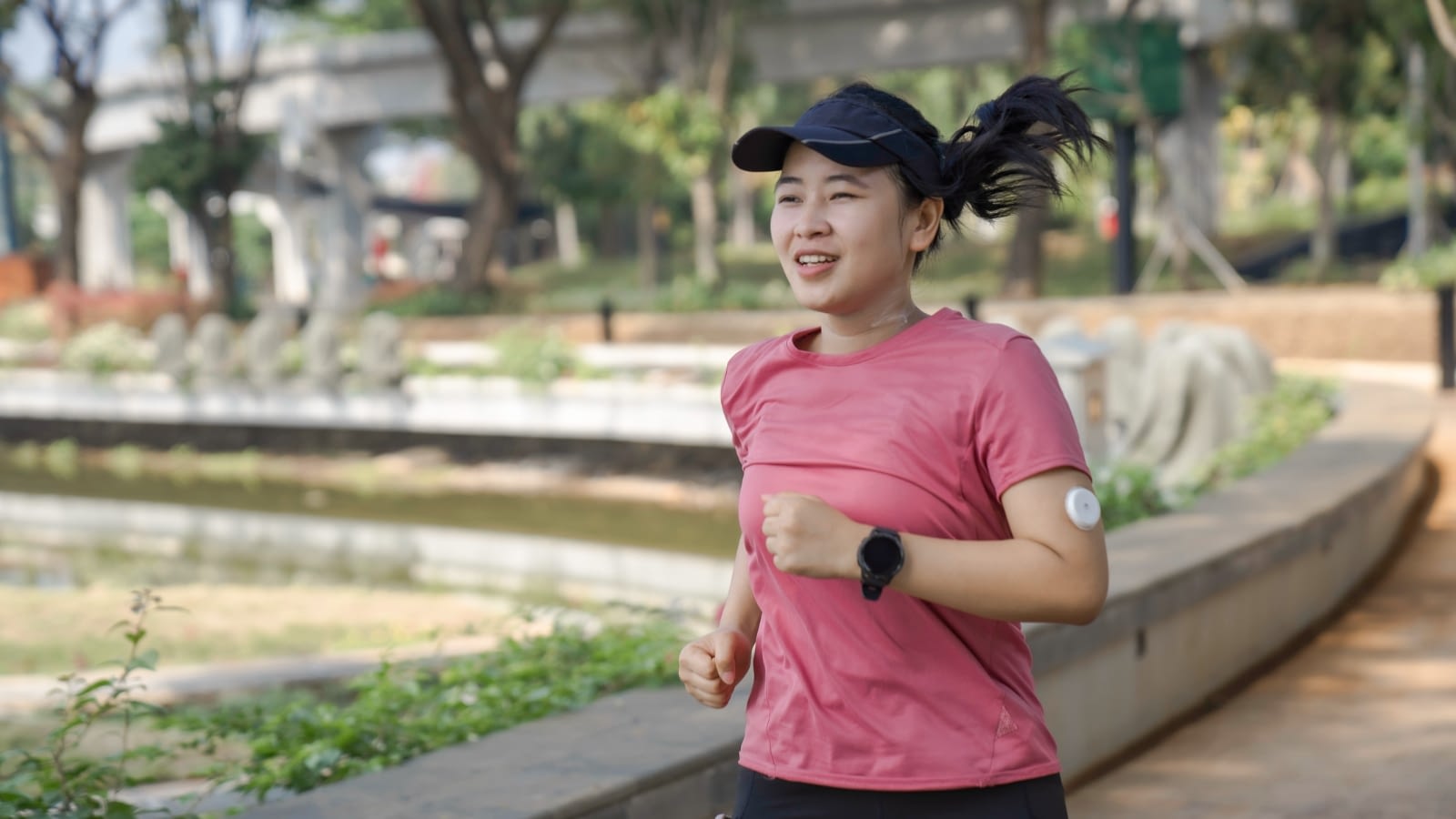 Young healthy Asian woman jogging.