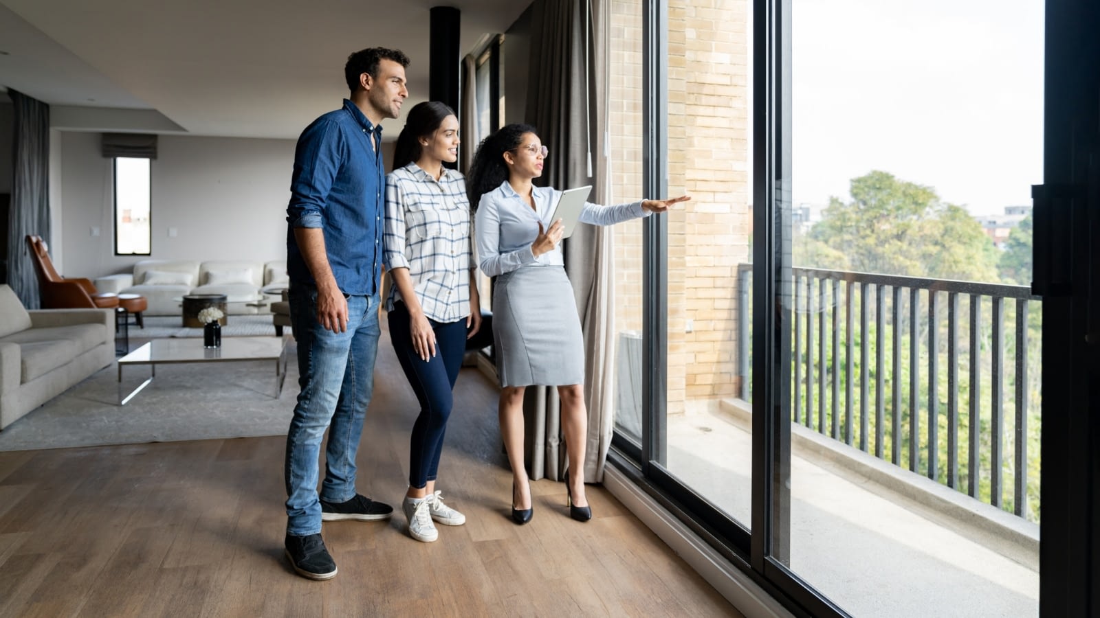 Young couple being shown a new condo by a real estate agent.