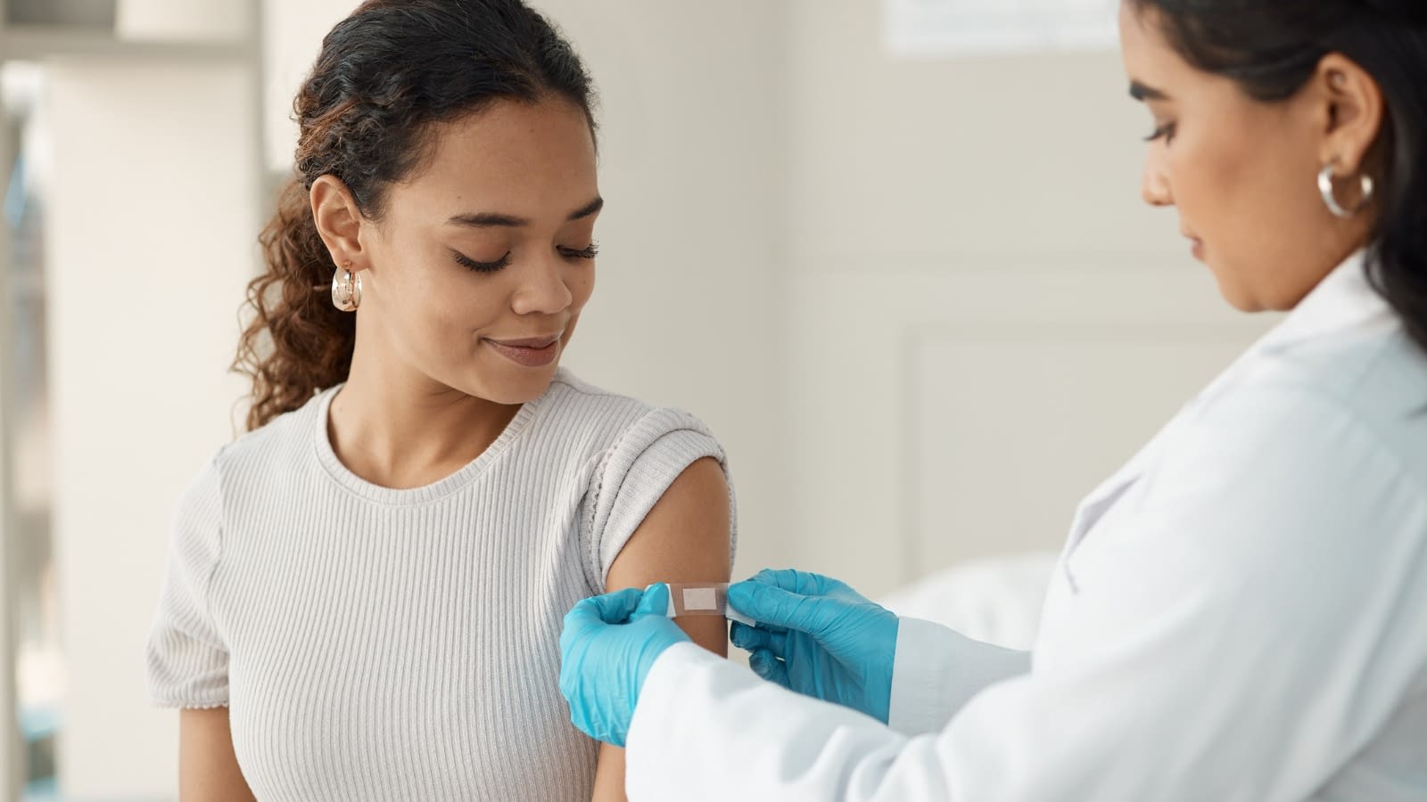 Young lady visiting doctor Woman just finished getting a shot