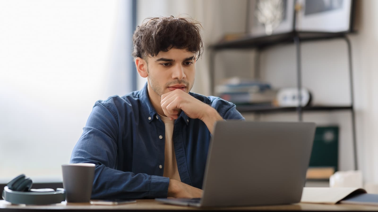 health insurance pensive man looking at laptop