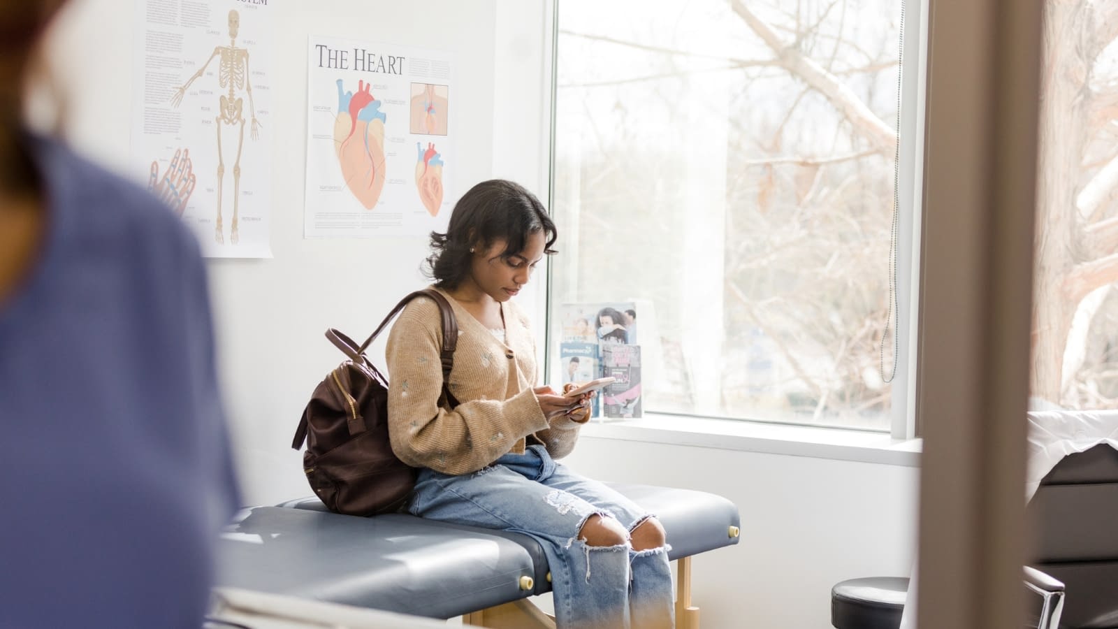 September 25 blog Young female college student sitting in doctor's office