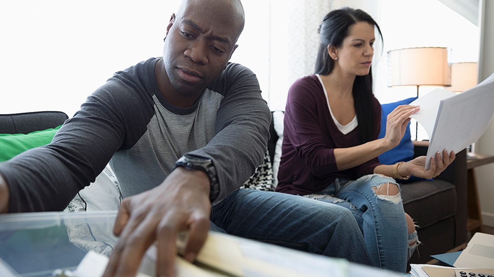 Couple looking through paperwork to find a lost life insurance policy