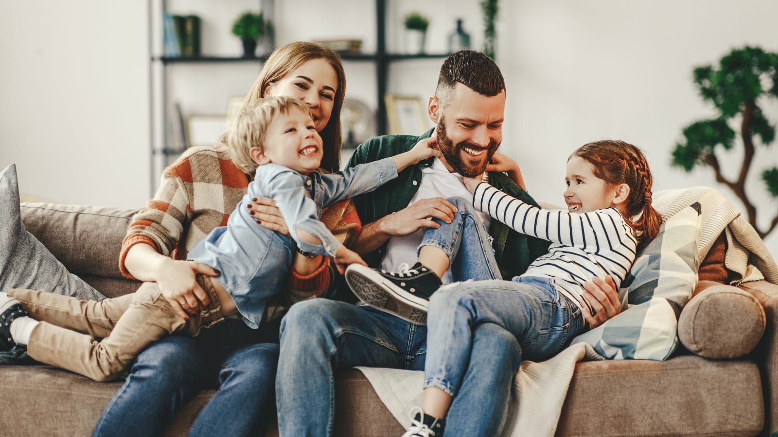 happy family playing on couch