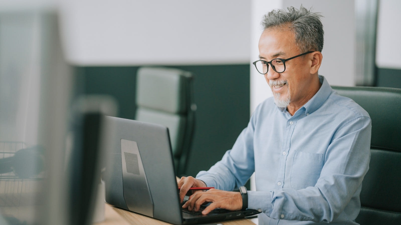 Asian man working on computer