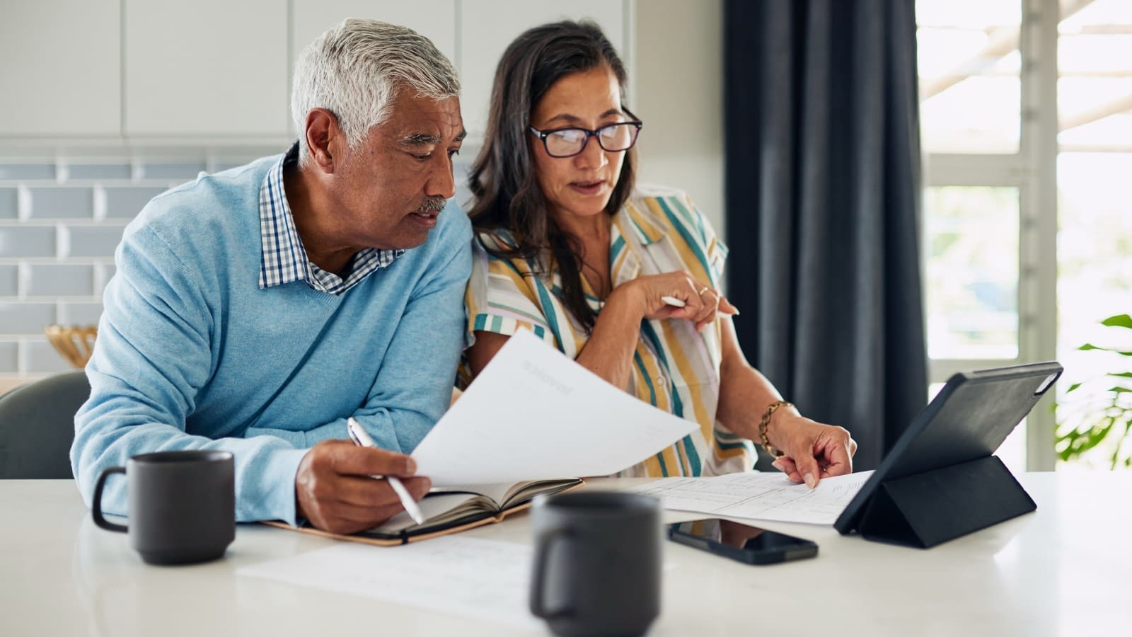 April 7 blog Older couple looking at their life insurance plan