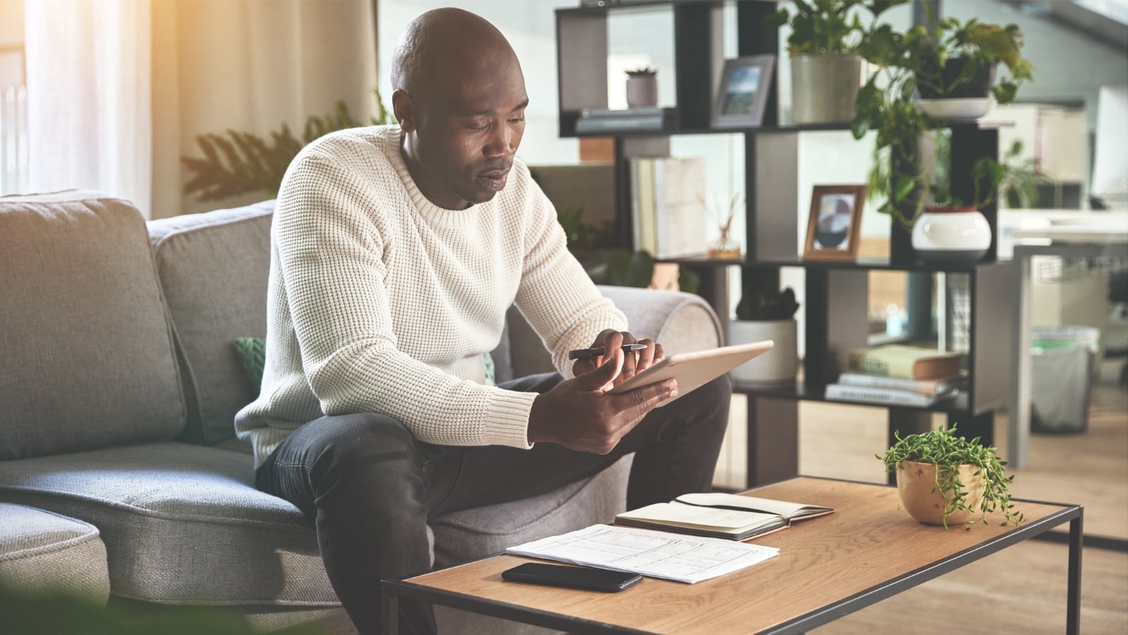 African-American man reading on iPad.