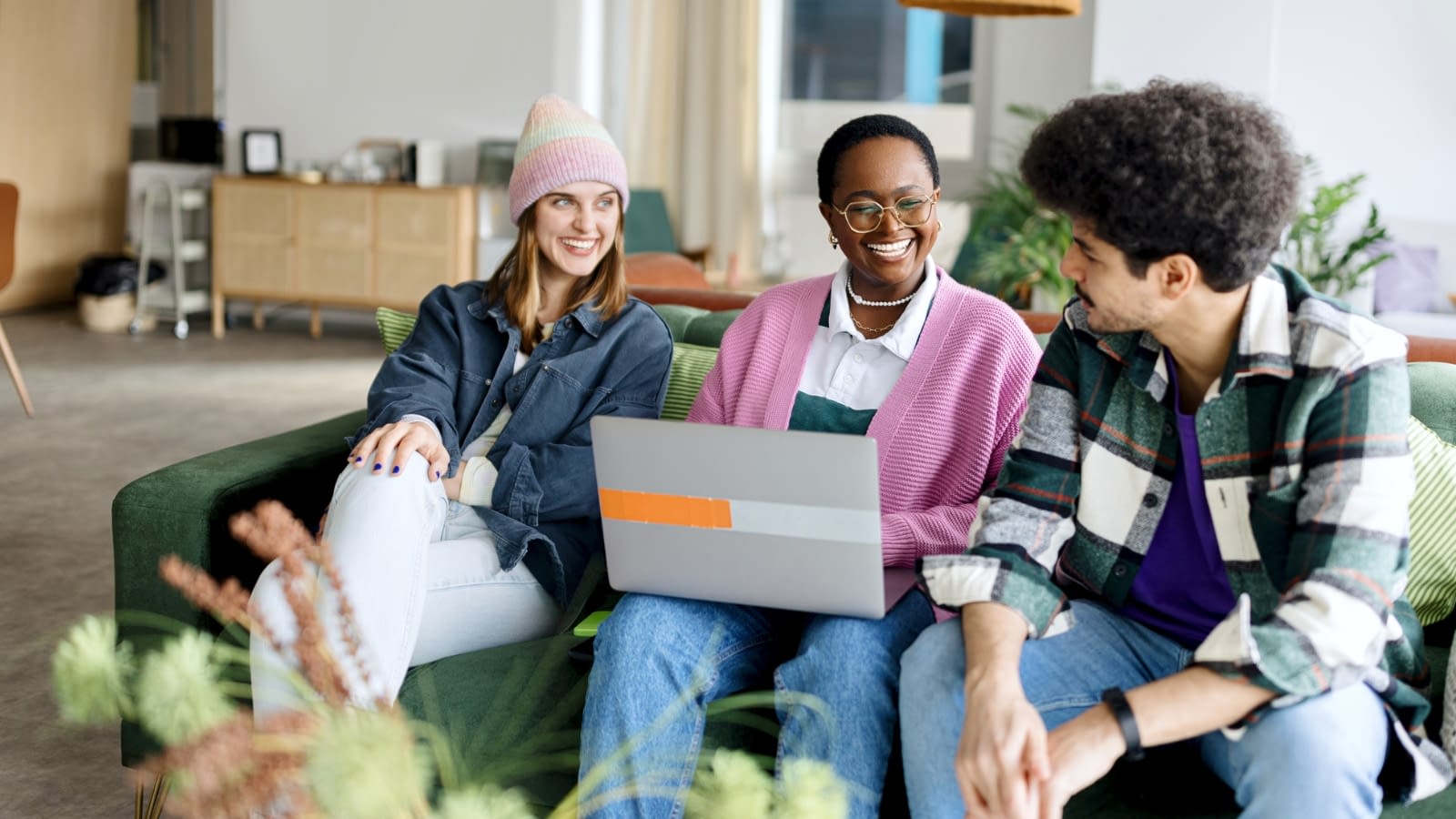 gen z group of gen zers sitting on couch laughing