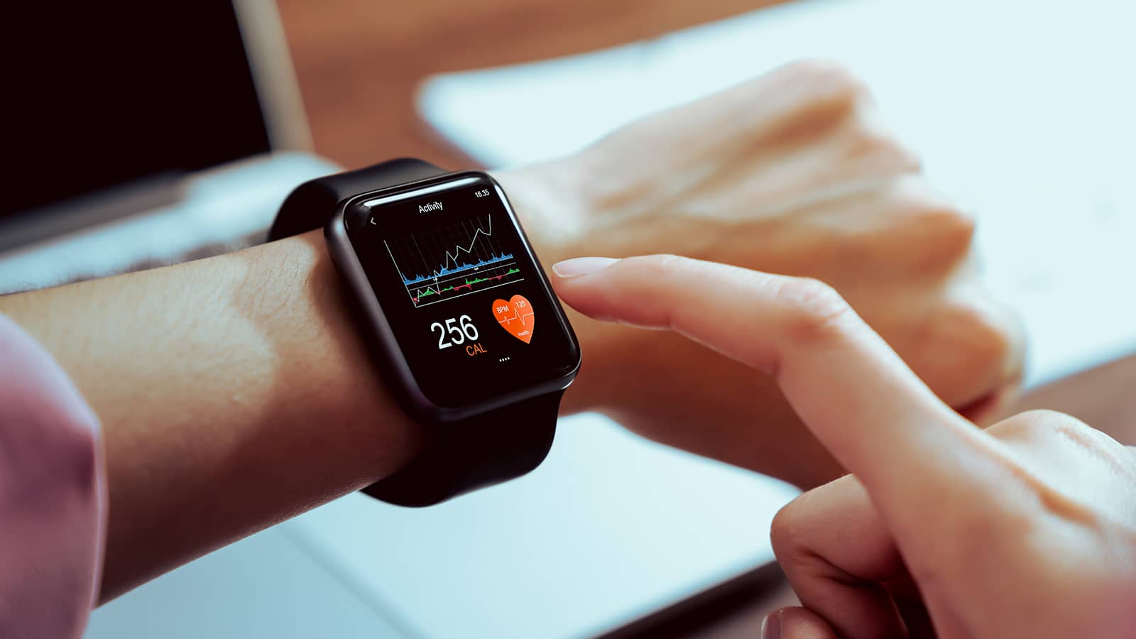 Person Tapping Health Metrics on Smart Watch