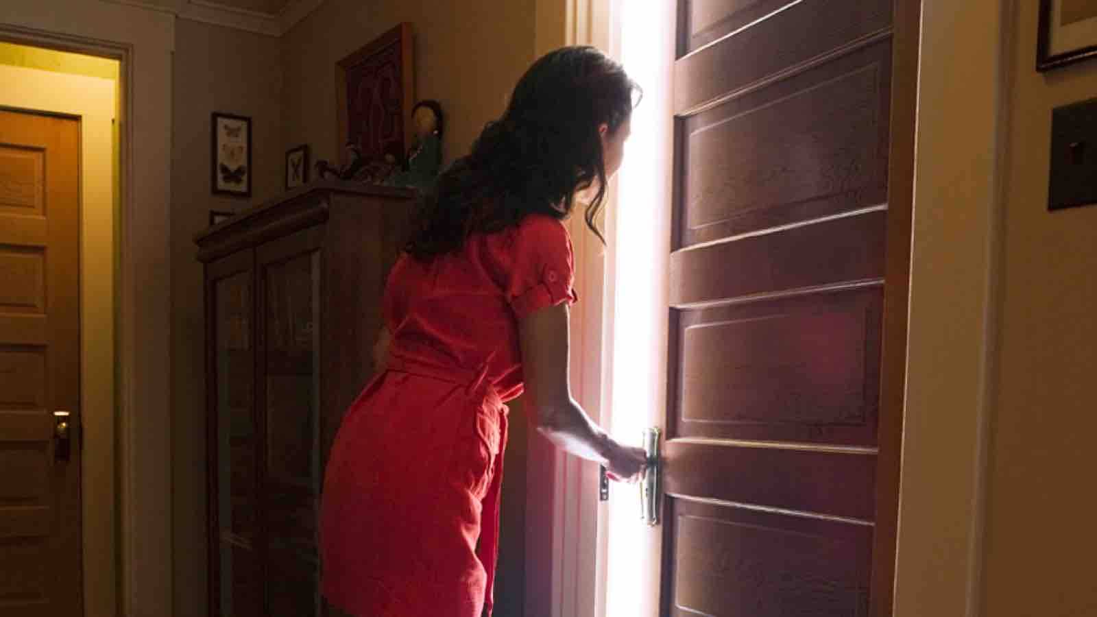 Woman opening her bedroom door