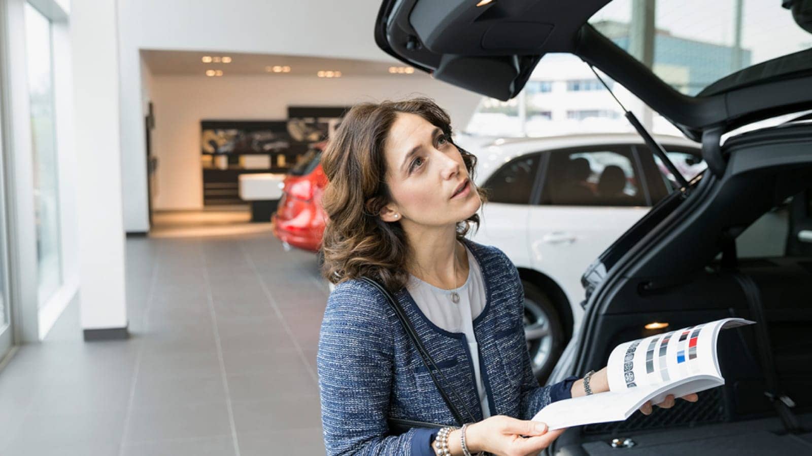 Woman looking at cars to buy