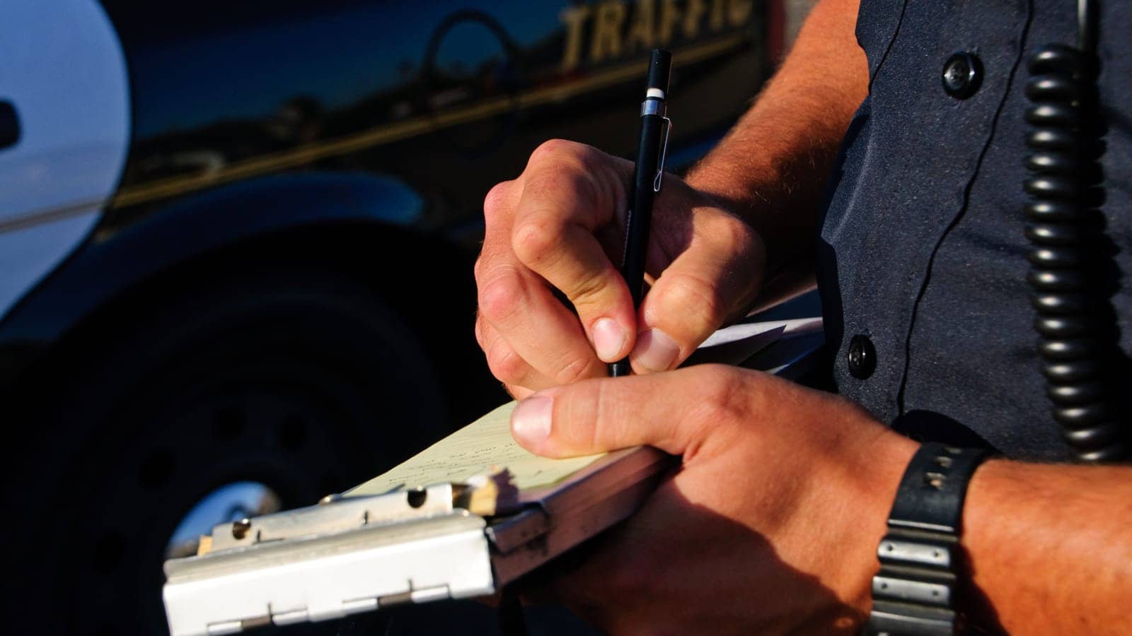 Cop writing a traffic ticket