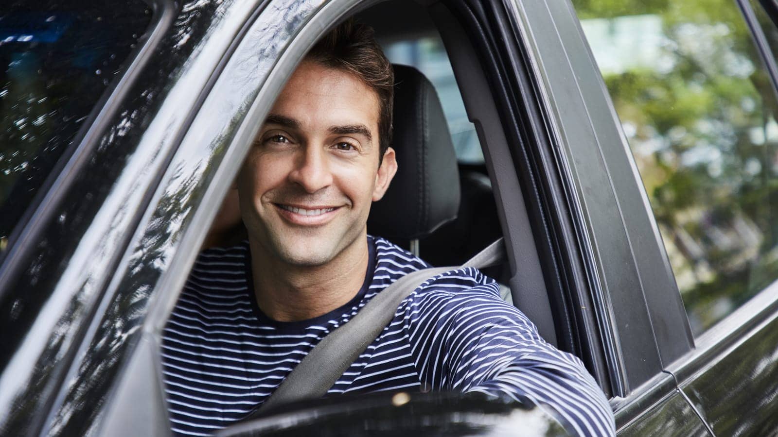 Young male driver smiling