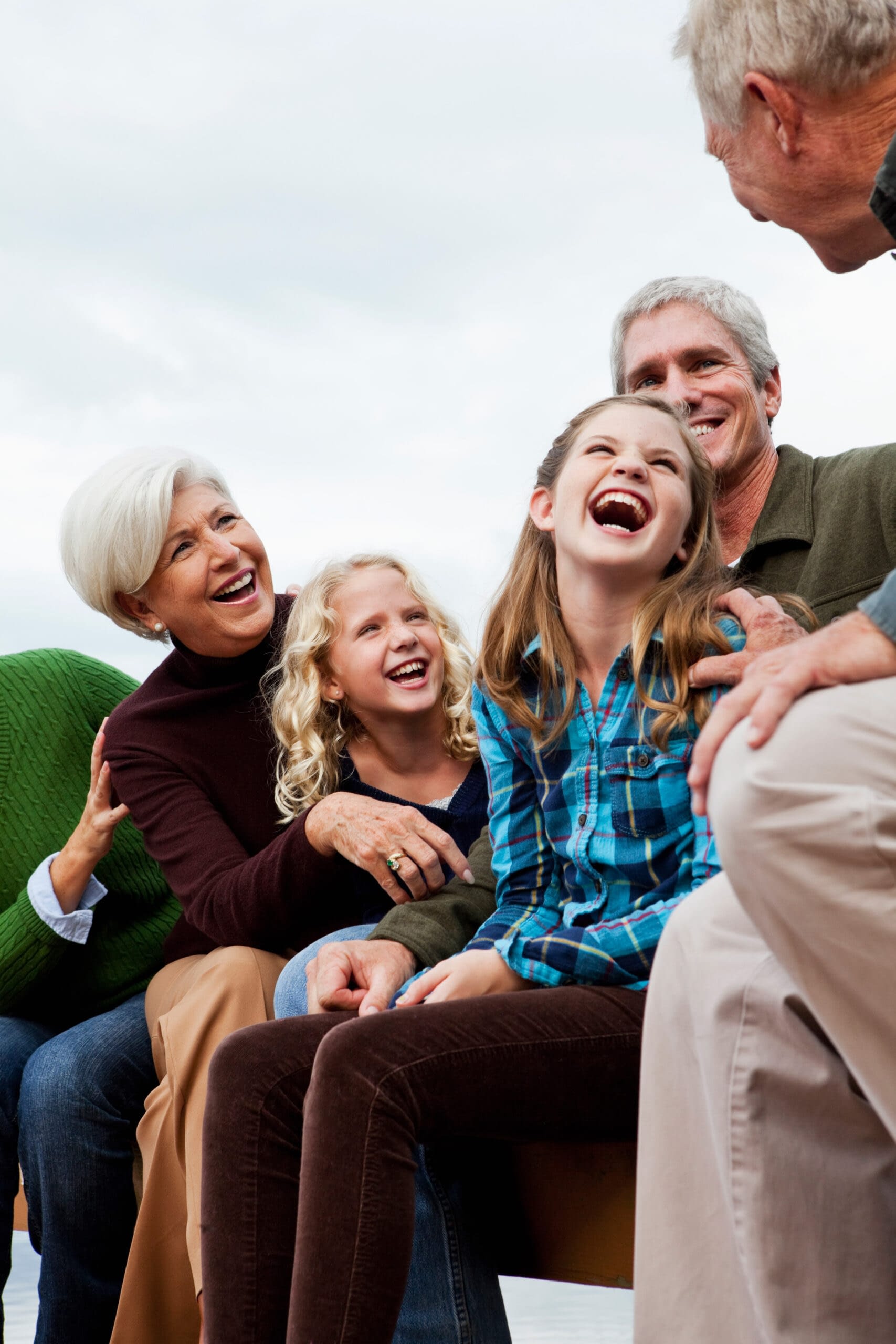Three generations laughing together.