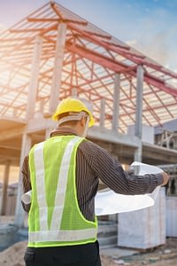 Contractor looking at blueprints