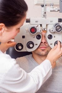 Female Doctor Examines an Adult Male's Vision