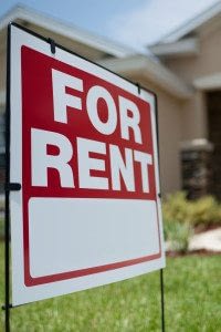 For Rent Sign In the Yard of A New Rental Property