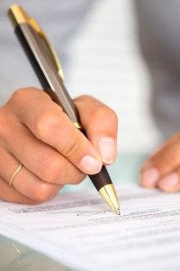 Hand Signing a Surety Bond