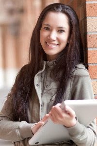 Businesswoman Holding Tablet and Smiling at the Camera