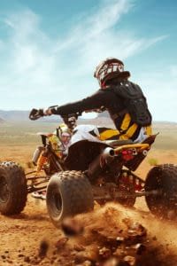 Person riding an ATV in the desert.