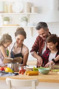 Family preparing a meal together in their kitchen.