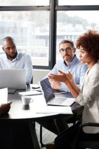A group of coworkers in discussion at a conference table