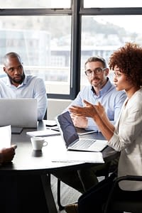 A group of coworkers in discussion at a conference table