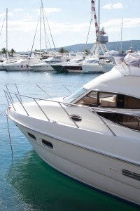 Boat On the Water in Front of Other Boats at a Marina