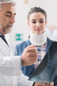 Doctor showing a young female patient her x-ray.