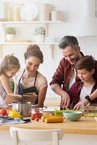 Family preparing a meal together in their kitchen.