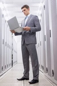 Businessman Standing with Laptop