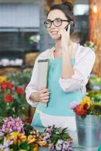 Young businesswoman on phone discussing QSHERA.
