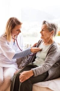 Nurse taking vitals of an elderly woman