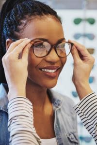 Young woman getting fitted with new glasses.