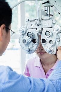 Male Doctor Conducts Vision Exam on His Female Patient