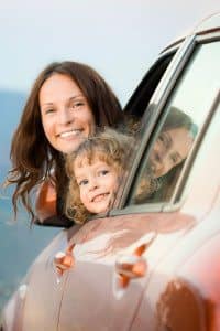 Mother and Daughter Leaning Out of Car Window