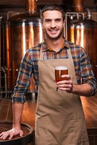 Bar and Restaurant Business Owner Holding a Beer and Smiling at Camera