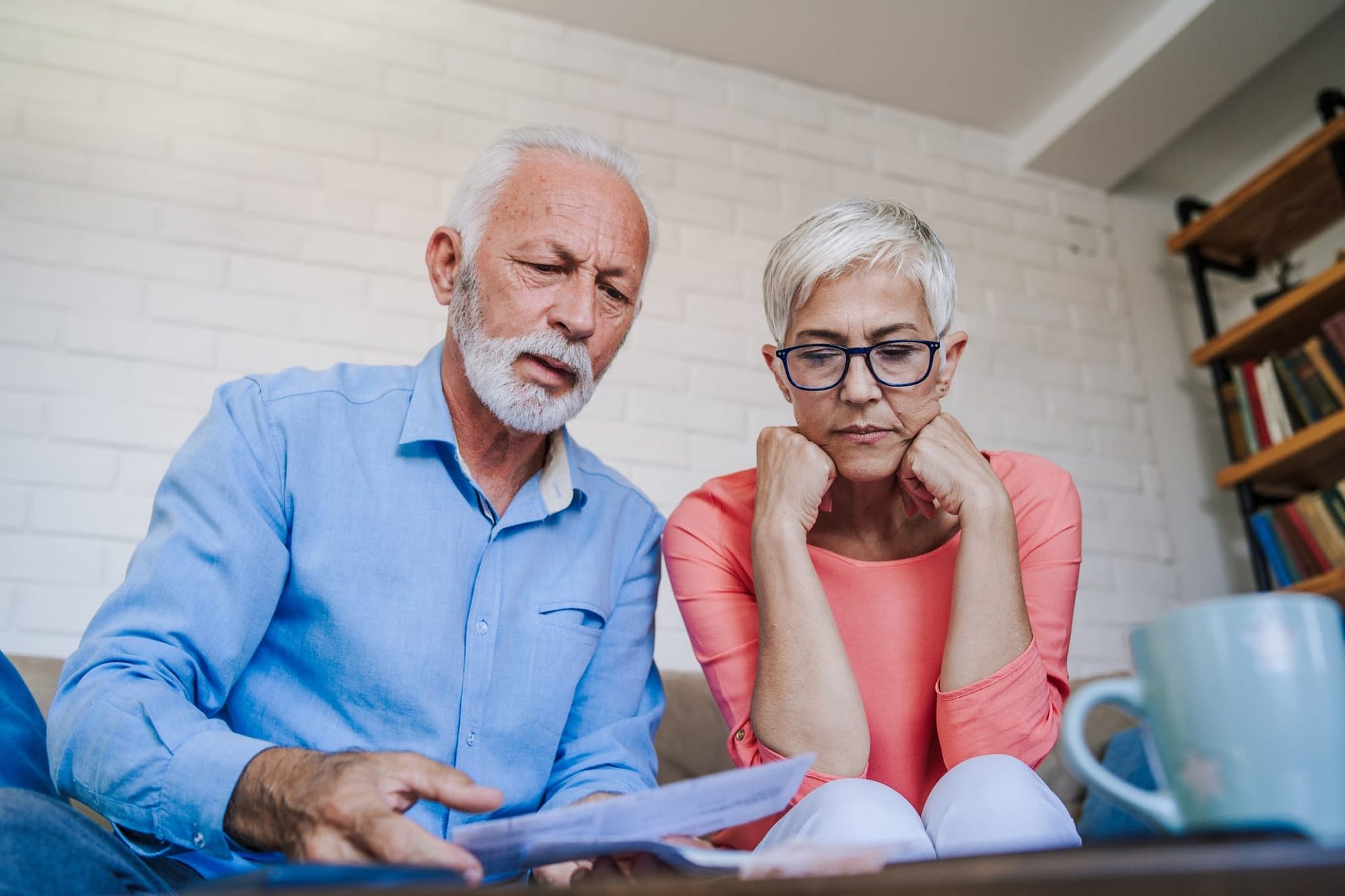 Concerned Senior Couple Looking at Paperwork