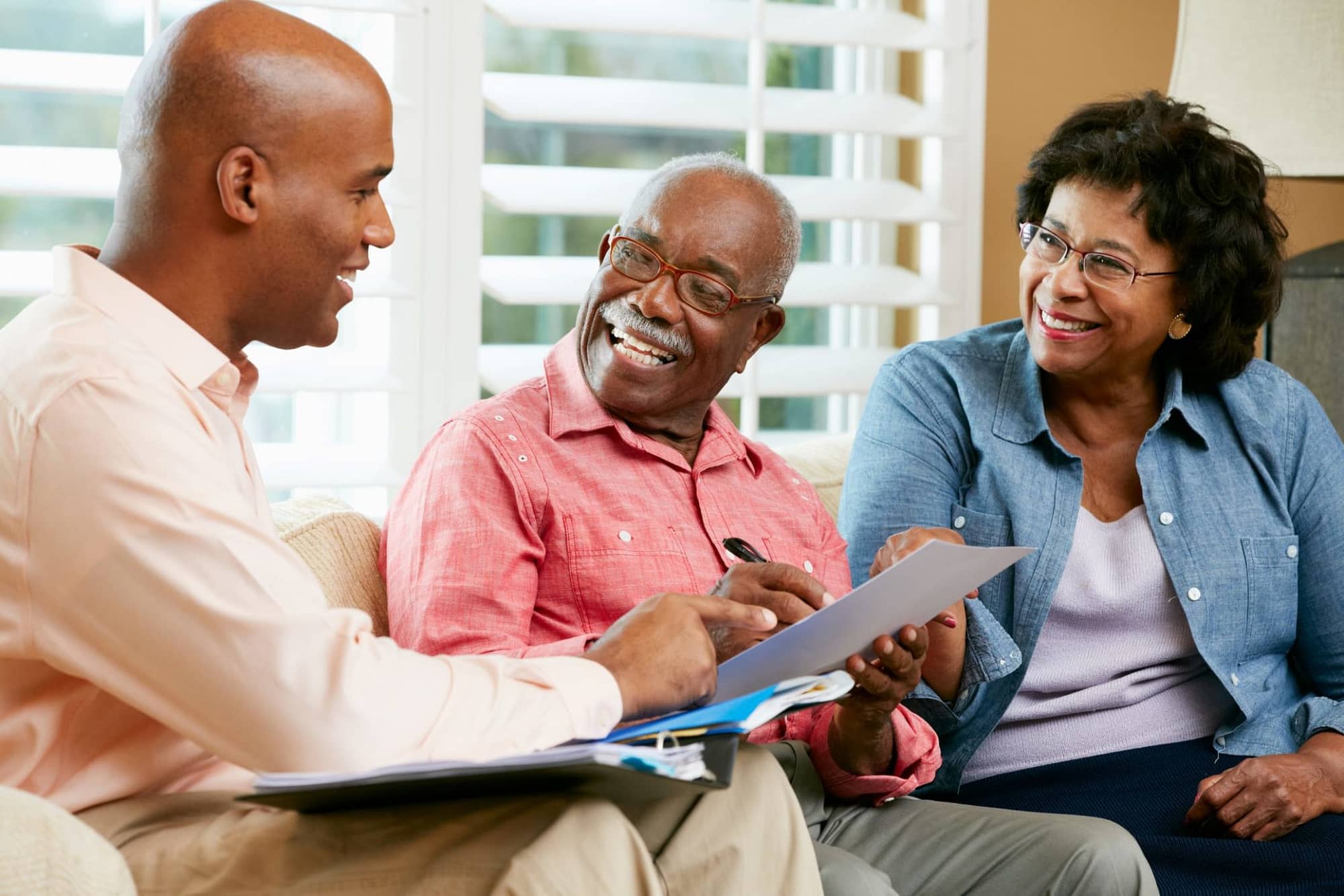 Senior African American Couple Talking to Consultant