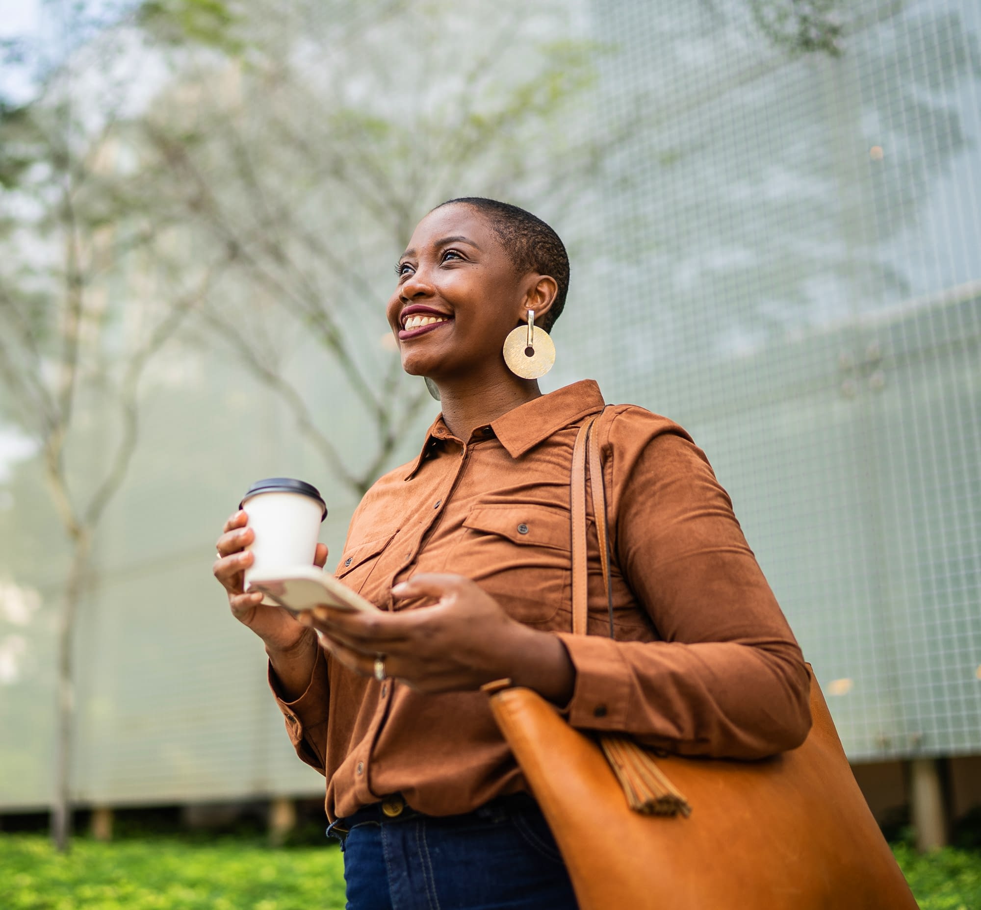 business woman holding phone while smiling