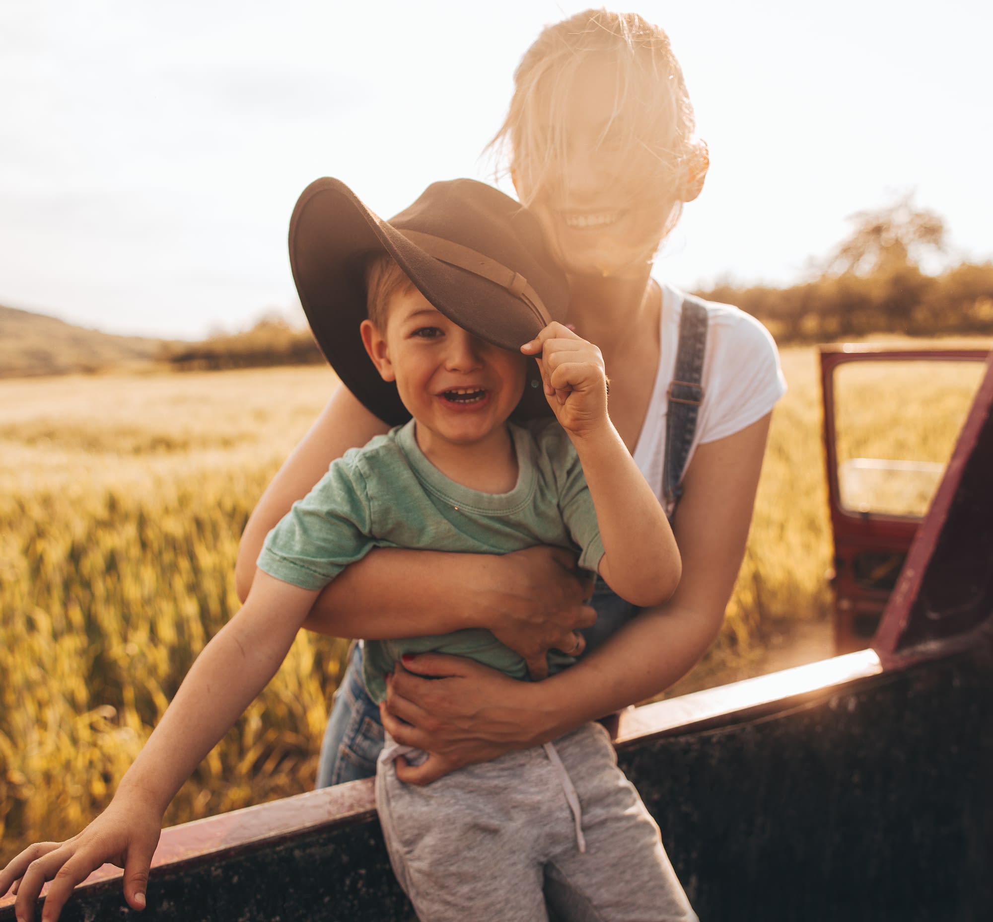 mother holding toddler during sunset